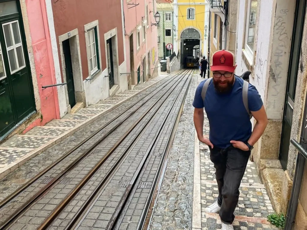 Daniel reed walking up hill wearing a red hat