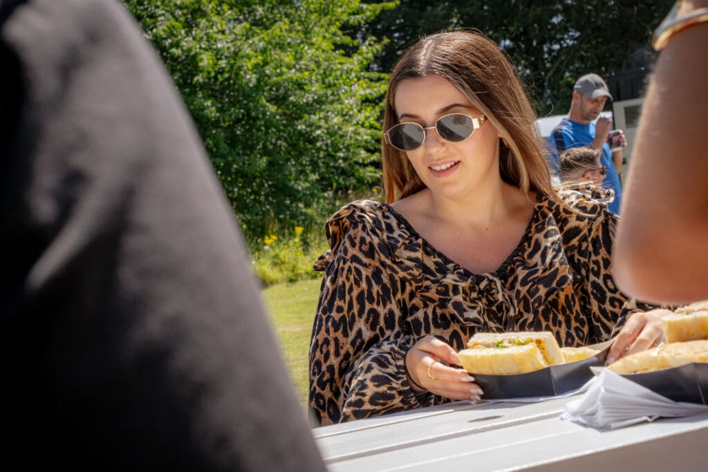 Lady wearing sungalsses at an outdoor event